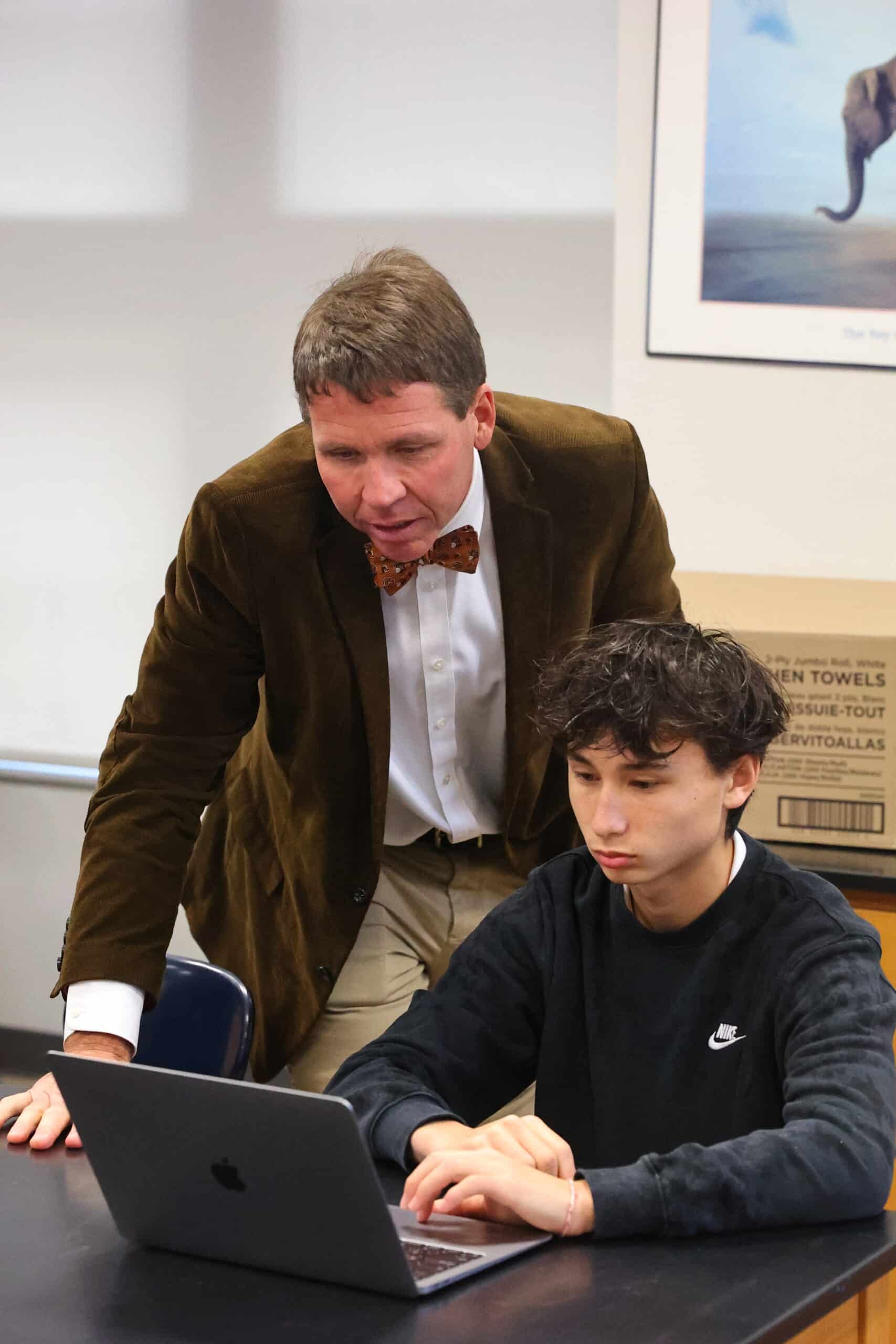 Teacher helping student
